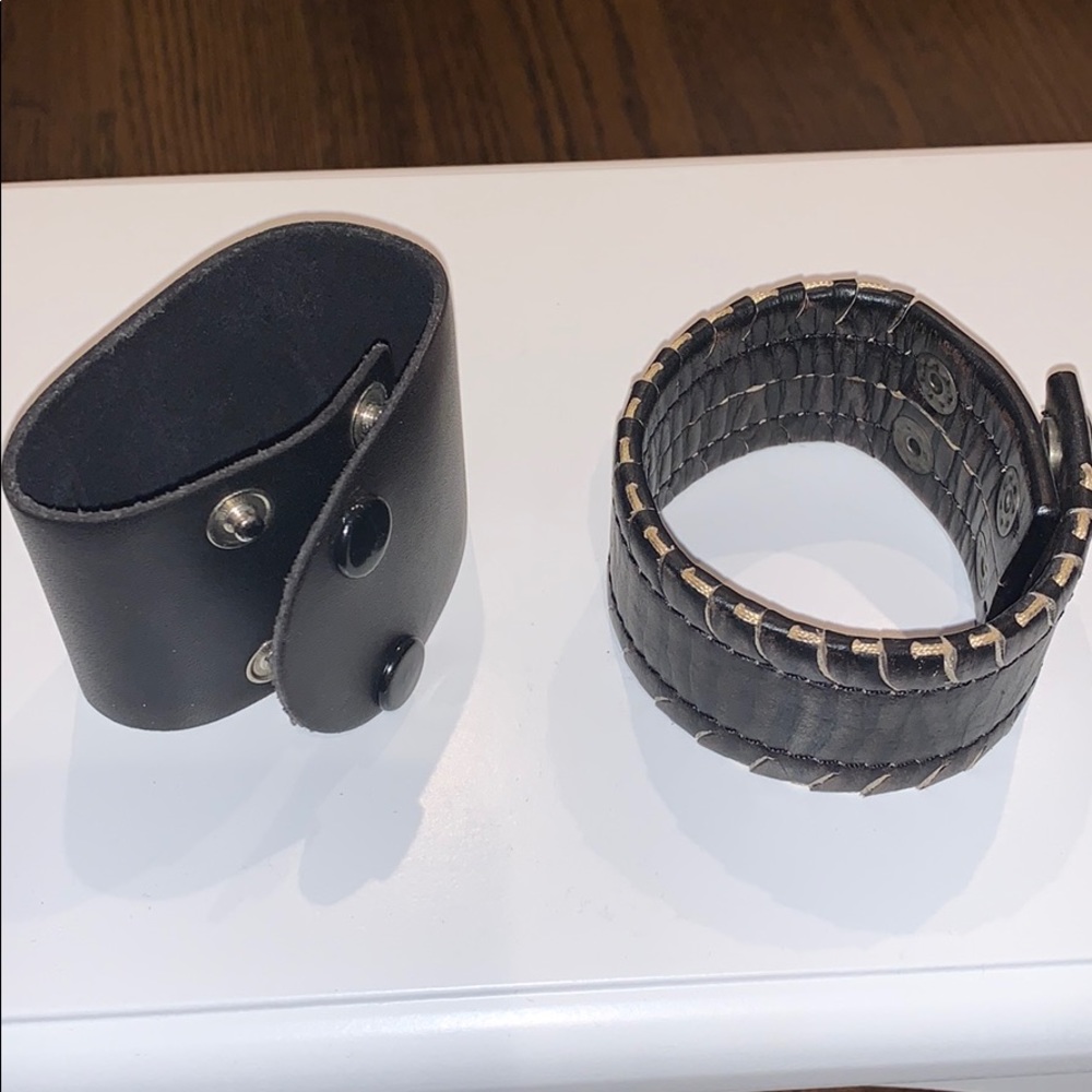 2 leather bracelets, 1 is brown and 1 is black